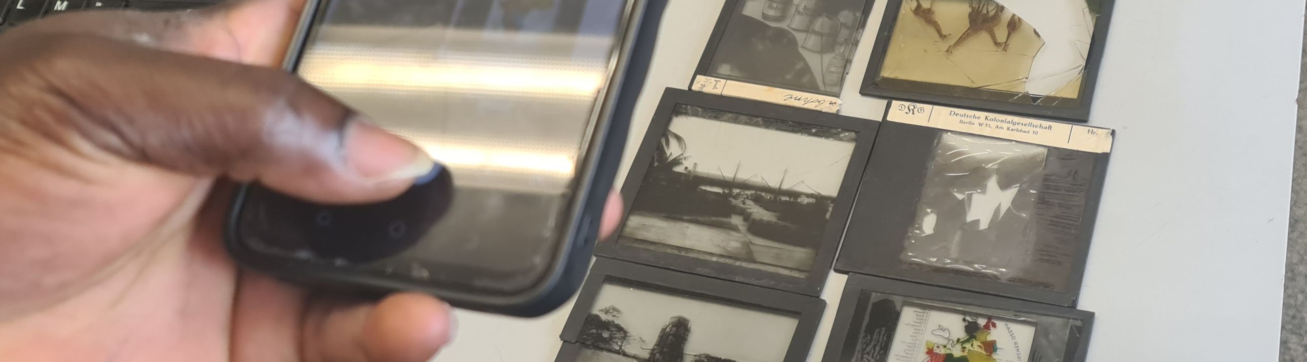 Negatives being photographed with a smartphone